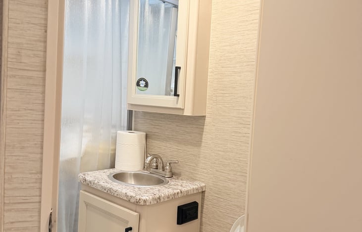 Bathroom with sink, mirror cabinet, and toilet
