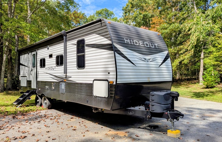 This spacious 2021 Keystone Hideout 250BH sleeps 8 with a bunkhouse layout, outdoor kitchen, and upscale interior. Features include: electric fireplace, central vacuum, outdoor kitchen, and more.