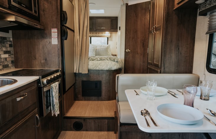 Dining on the table (which can later convert to a bed), pull the privacy shade for the master bed if you need