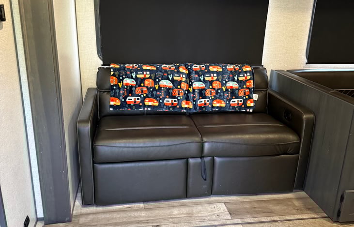 This is the view when you first walk in using the left door. A comfy couch that turns in to a bed right in front of the TV and fireplace. Can sleep 1 adult or 2 kids.