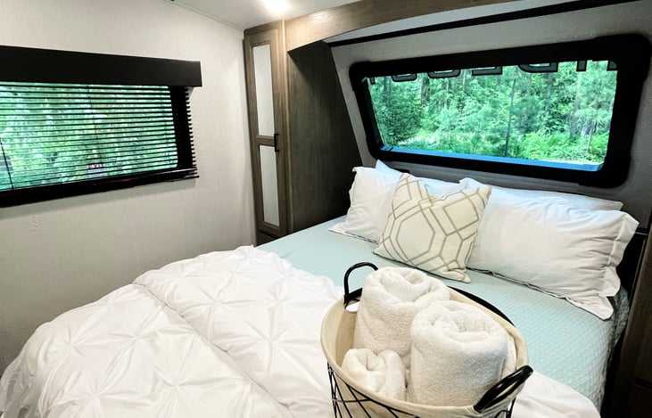 Giant windows in the master bedroom allow you to take in the scenic surroundings. Bed comes with all linens shown in photos.