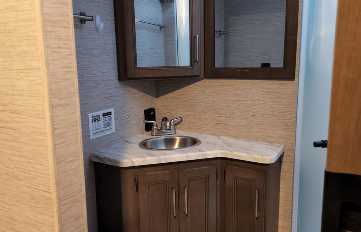 Bathroom with a Little Placard Reminder to Use the RV Toilet Paper