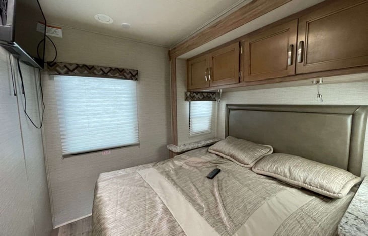 queen sized bed fits my wife and my 6' frame comfortably.  There's even a place for my CPAP machine. There's a few feet of space between the bed and wall.