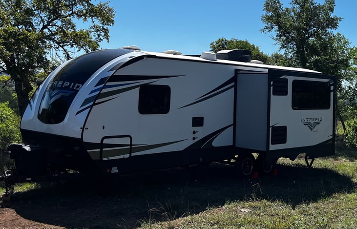 Slide out for an expanded living room. Outdoor shower with an emergency window in the front room.