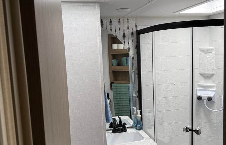 Large bathroom with overhead vent fan.