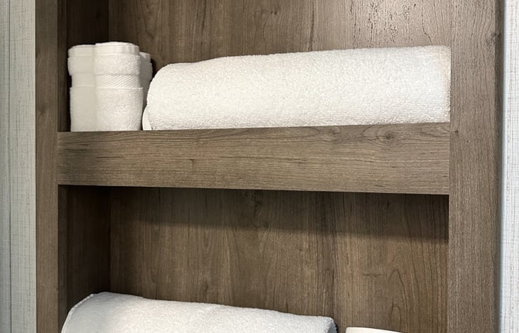 Towel rack or storage area for things for storage in bathroom.