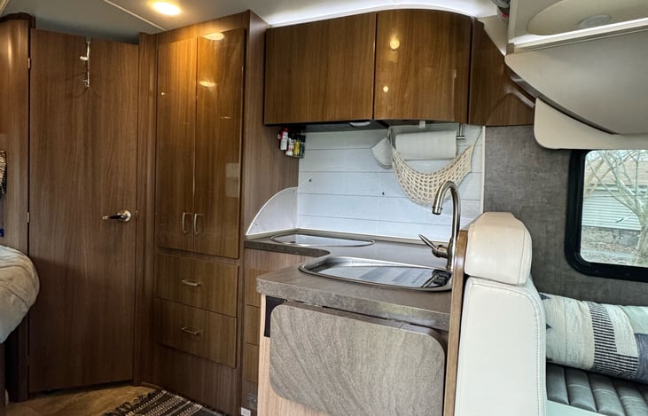 The kitchen comes stocked with dinnerware, utensils and cooking necessities, including basic spices. There is a 2 burner cooktop, deep sink, and the counter extends, providing ample prep space.