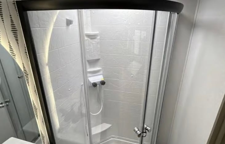 Full bathroom with instant hot water system.