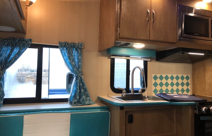 Interior - booth area is situated in rear of cabin, next to kitchen. Dinette turns into small double bed. Area includes bluetooth home theater stereo with speakers