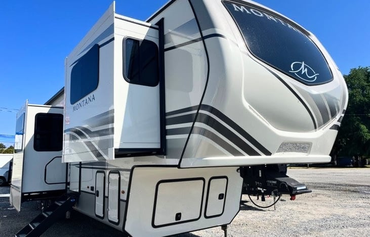 This Montana Legacy is a true 'mansion on wheels' with 5 slide outs, front Living Suite, King bed, Chef's kitchen, Bath and a half, hardwood cabinets, ample storage, fireplace and much more!