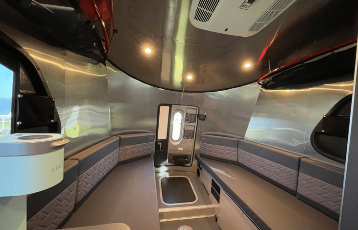 The rear lounge of the Basecamp 20X offers an incredibly spacious, dual-purpose living area. During the day, parallel benches provide a comfortable, sunlit lounge for dining, relaxing, or work.