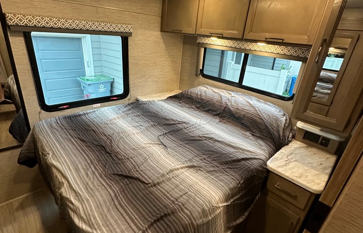 Bedroom has a RV queen with lots of storage. 2 closets with hanging rods. Overhead and under the bed storage.