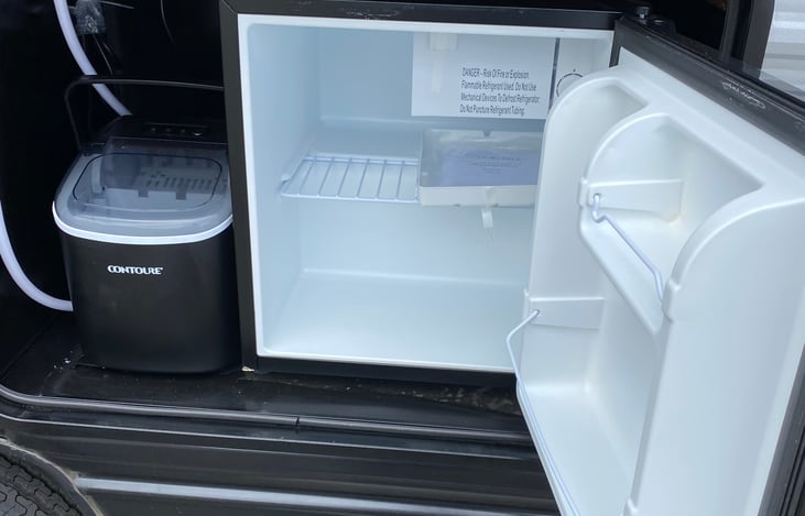 Outdoor kitchen with ice maker and mini fridge