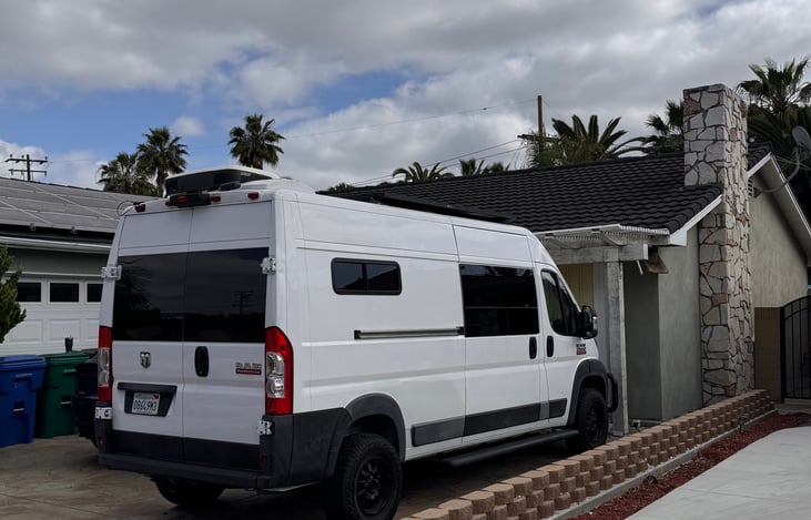 Exterior of van, rear view with A/C unit on top of van.