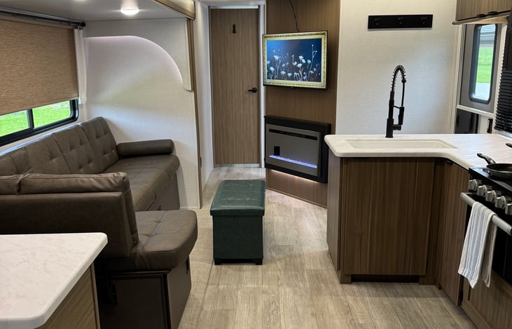 Spacious living area with tv and fireplace.