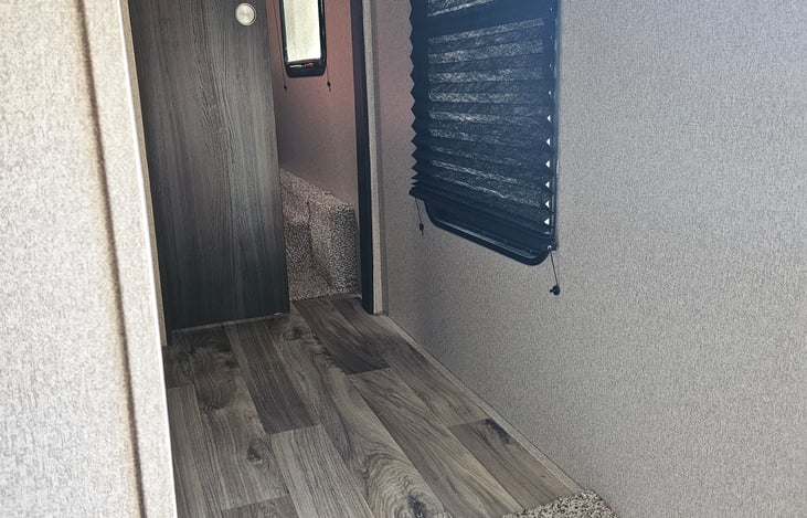 Hall to queen bedroom with sliding door