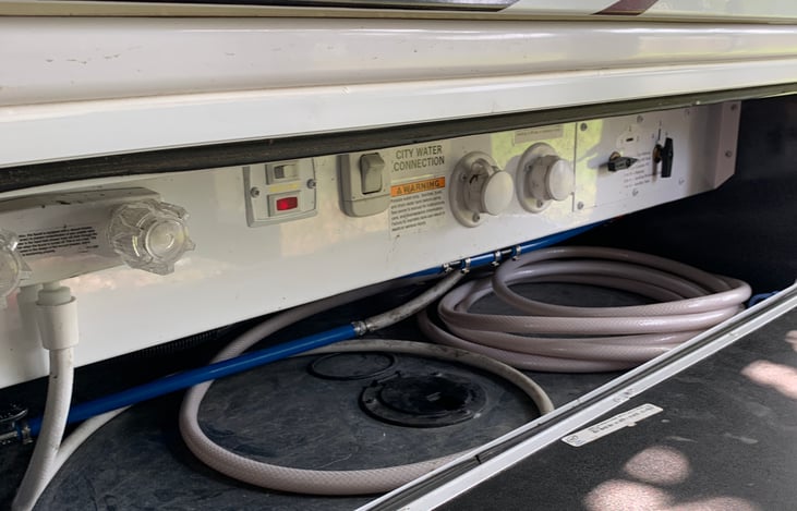 Driver-side basement with water connections.