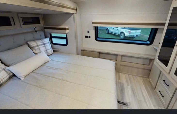 Primary bedroom with private access, and sliding door for privacy. Ample storage above and below bed as well a built in wardrobe.