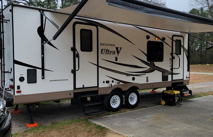 Electric Awning with Led Lights and Wind Sensor, outside shower and electrical outlet, easy access via dual doors, propane outside grill