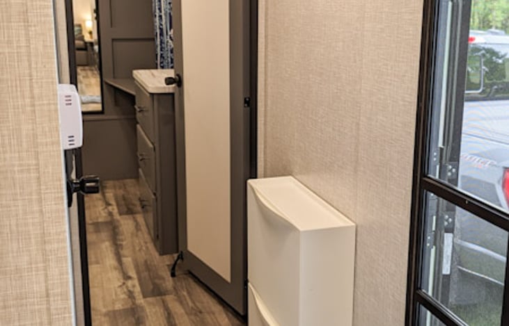 Entryway/hallway with shoe storage and coat hooks.