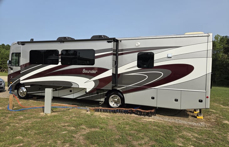 Full view of driver's side of RV with living area slide out extended.