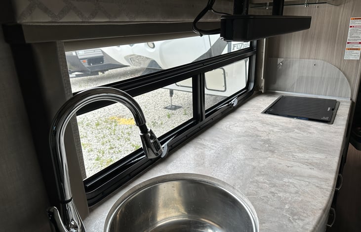 Sink and propane cooktop.  Microwave and Air fryer underneath