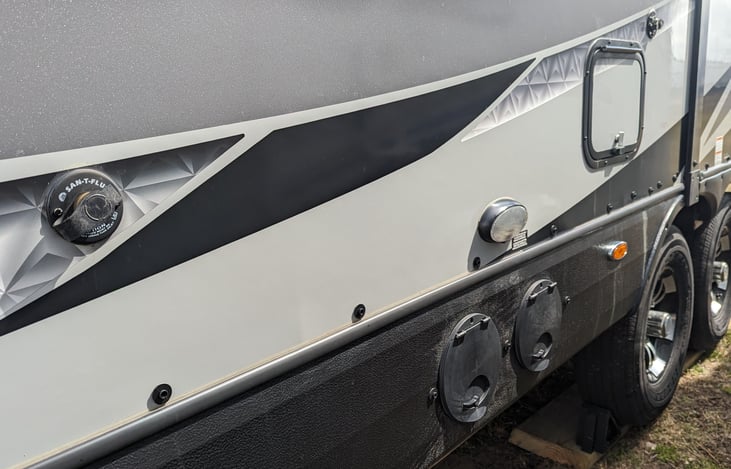 Black and Gray tanks located on LH side.