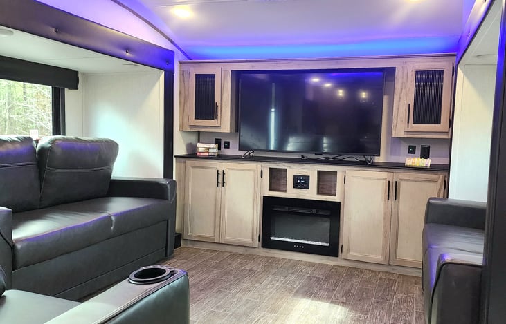 Roku TV with 2 pull out couches, 2 person theatre chair & electric fireplace