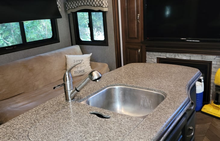 Double sink, has cover for extra counter space.