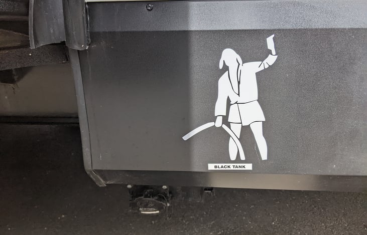 "Cousin Eddy" denotes where the black tank dump valves are.  There are two of them.