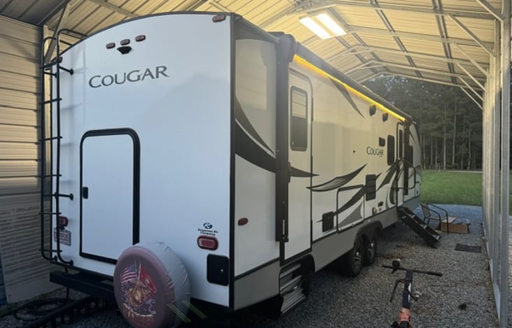 Rear door for easy loading of storage area in re bunk bed location.