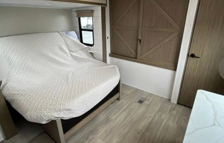 King bed with ac unit in room. Full storage closet and dresser.