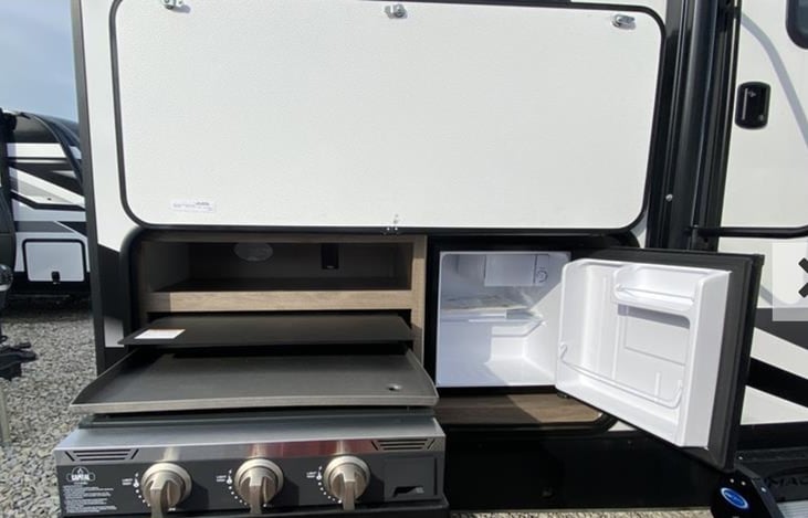 Outdoor griddle and mini fridge.