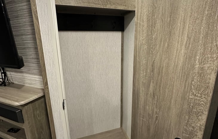 front entry storage closet to right of tv, great for coats, shoes, or storage.