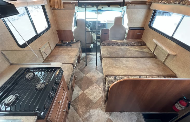 Both dining tables converted to sleeping quarters:  bed on left is 25" x 63" (closest to twin size, which is 38" x 75").