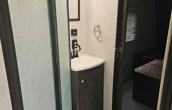 The bathroom has the basics, and offers 2 entry points which adds separation from the main living space.