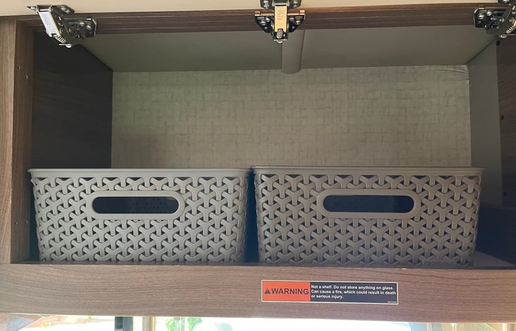 Kitchen space above stove with two empty bins for organization