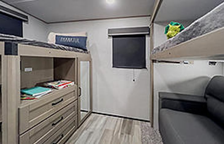 The Bunk Room has two upper bunks and a sleeper sofa. It also has it's own half bath, which is very nice when travelling with children. We have a guard rail available for small children safety.
