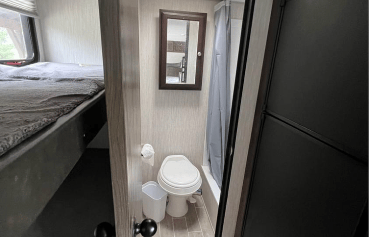 Door to restroom and bunk beds.