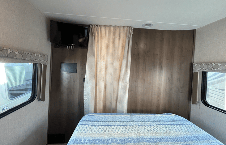 TV in master bedroom, with a privacy screen.