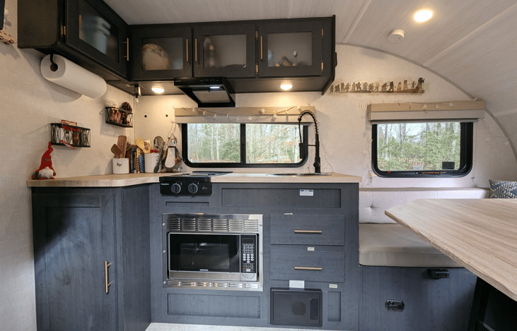 Cozy, modern and bright living area with well-equipped kitchen, TV, large dinette that converts to a bed, pop-out window and whimsical touches throughout.