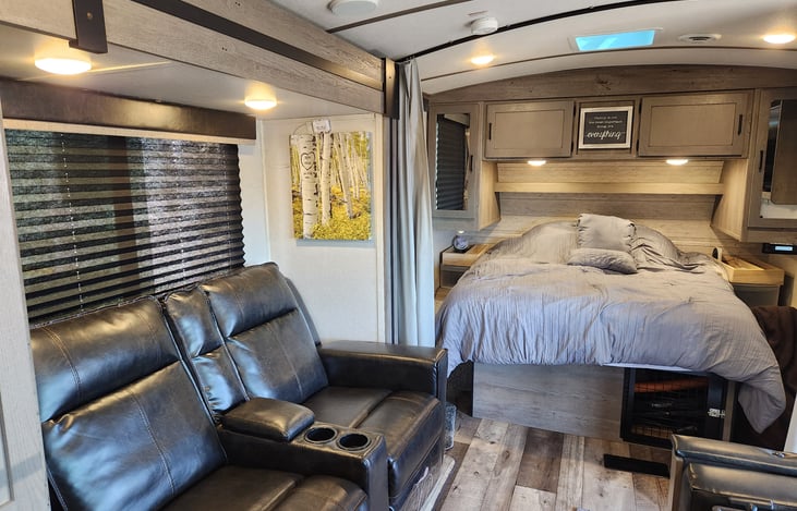 Take a long nap or eat dinner in the theatre recliner chairs on the TV that swivels toward the bedroom or the rest of the cabin. Extra storage under Queen Bed