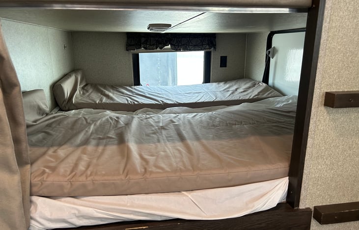 Bottom bunk. Bunks all include foam toppers for comfort.