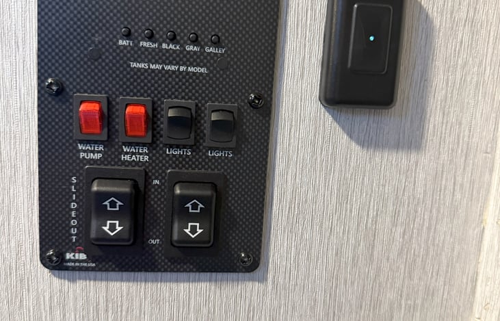 Battery and liquid tank checks, water pump and water heater switch.  Accent and outside light switch.  kitchen slide out and front canopy switch.  Main interior light switch with dimmer.