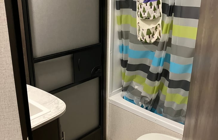 Bathroom with interior and exterior entrance doors