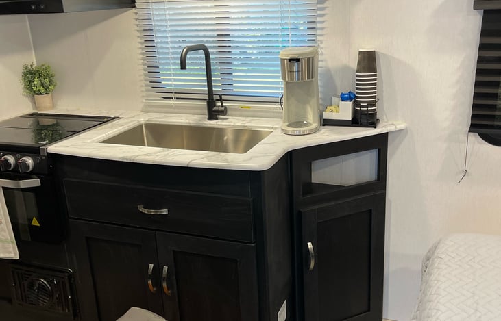 Full stainless-steel sink  and  4 burner stove