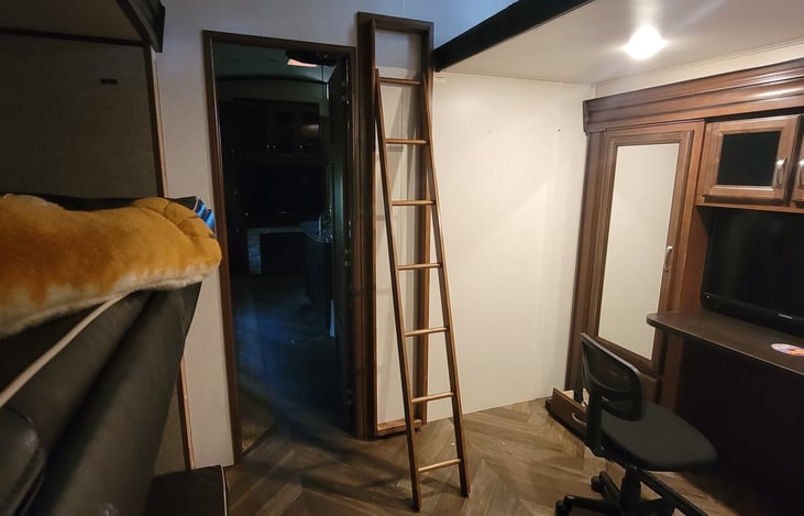 Large Bunk room with a ladder that leads up to the loft.