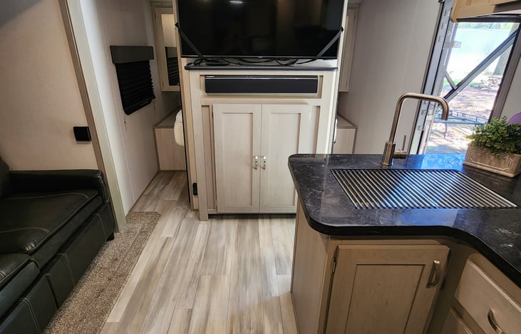 50" TV with sound bar. The sound bar has two zones. Zone 1 is for inside and zone 2 is the outdoor speakers or you can use both zones at the same time. Blue Tooth capabilities.