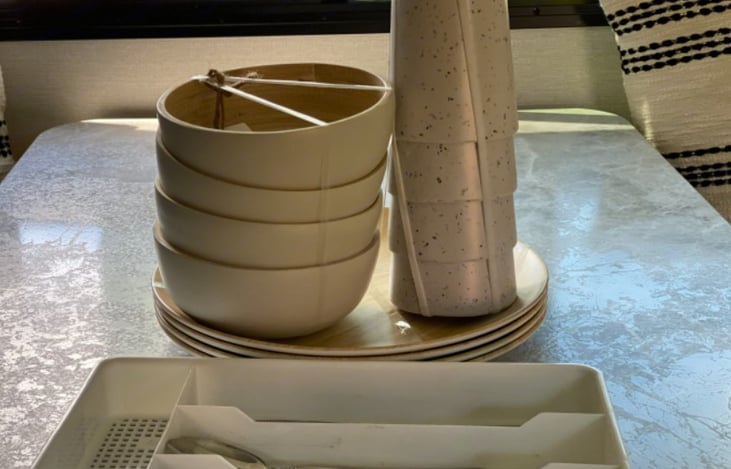 Melamine plates, cups, and bowls. Cutlery is included.