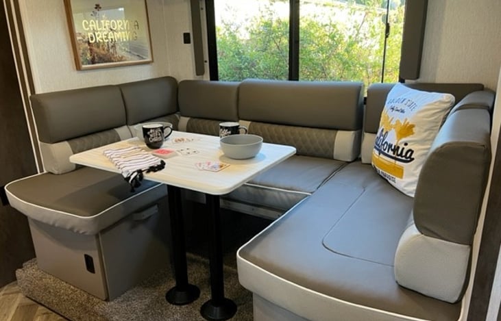 Convertible dinette with storage underneath. Be sure to bring extra bedding and foam mat if you plan to use the dinette for sleeping.